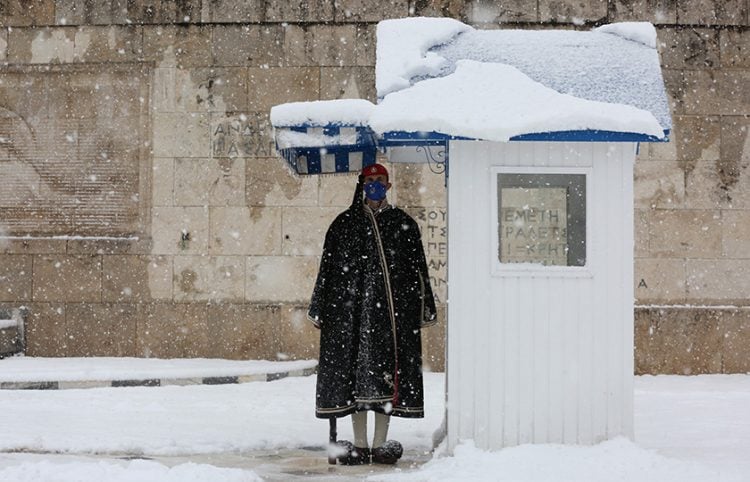 Εύζωνας στέκεται κάτω από το φυλάκιο του μπροστά από το κτήριο της Βουλής (φωτ.: ΑΠΕ-ΜΠΕ / Ορέστης Παναγιώτου)