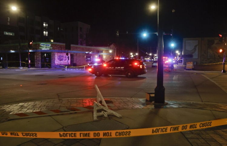 epa09597014 Police vehicles block an intersection where  crowds attending a Christmas parade along the route were strack by an SUV which reportedly broke through a barricade and drove into people including children, leaving multiple people dead and many more injured in Waukesha, Wisconsin, USA, 21 November 2021. The vehicle was recovered by police and a person of interest is in custody.  EPA/TANNEN MAURY