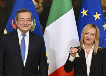 epa10260558 Italy's outgoing Prime Minister Mario Draghi (L) hands over the bell used by the cabinet president to manage cabinet debates to Prime Minister Giorgia Meloni (R) during the handover ceremony at Chigi Palace in Rome, Italy, 23 October 2022. Newly elected Prime Minister Giorgia Meloni and her cabinet were sworn in on 22 October.  EPA/ETTORE FERRARI