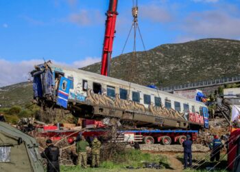 Γερανός σηκώνει ένα από τα μοιραία βαγόνια, προκειμένου να ερευνηθεί καλύτερα η περιοχή από τα σωστικά συνεργεία (φωτ.: EUROKINISSI/Λεωνίδας Τζέκας)